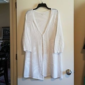 White cardigan with palm tree details on it.